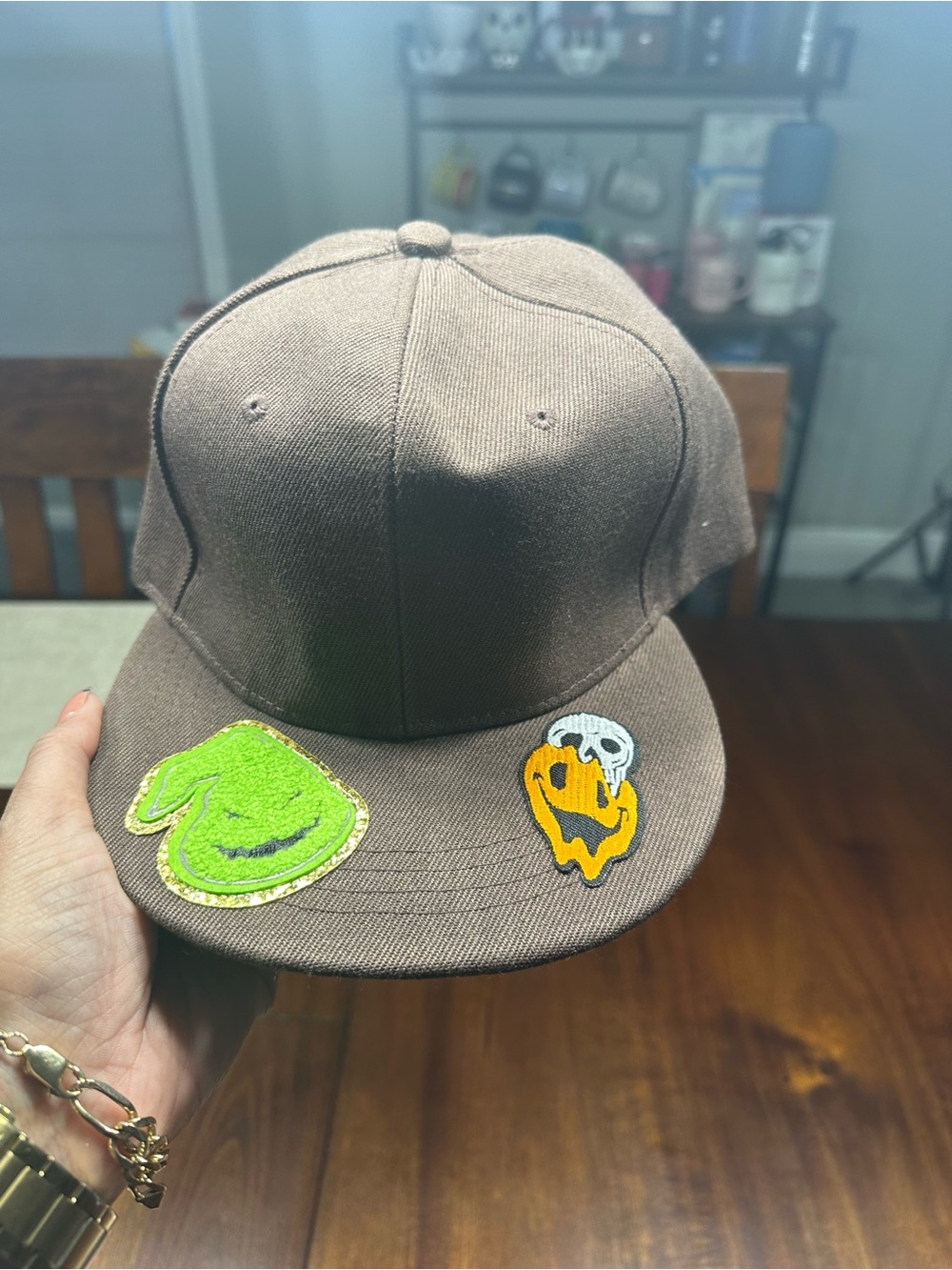Adult Brown Snapback hat with Green & Orange Patch Details. Great for Halloween.